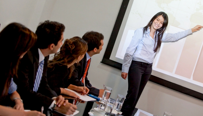 resilience is essential for leaders - meeting woman pointing to presentation in a boardroom 